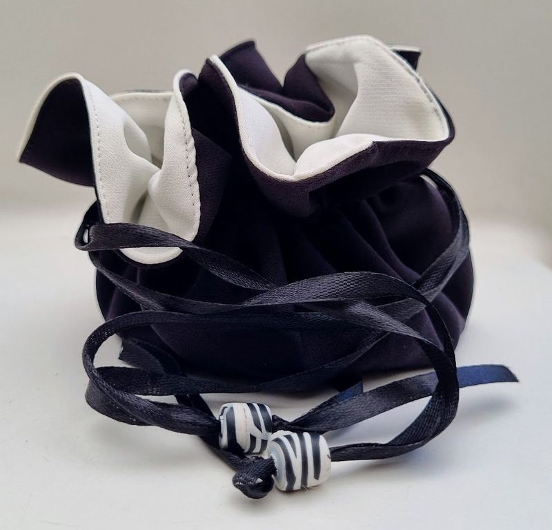 A light and compact travel jewellery bag in black and white with zebra patterned polymer clay beads – JB07