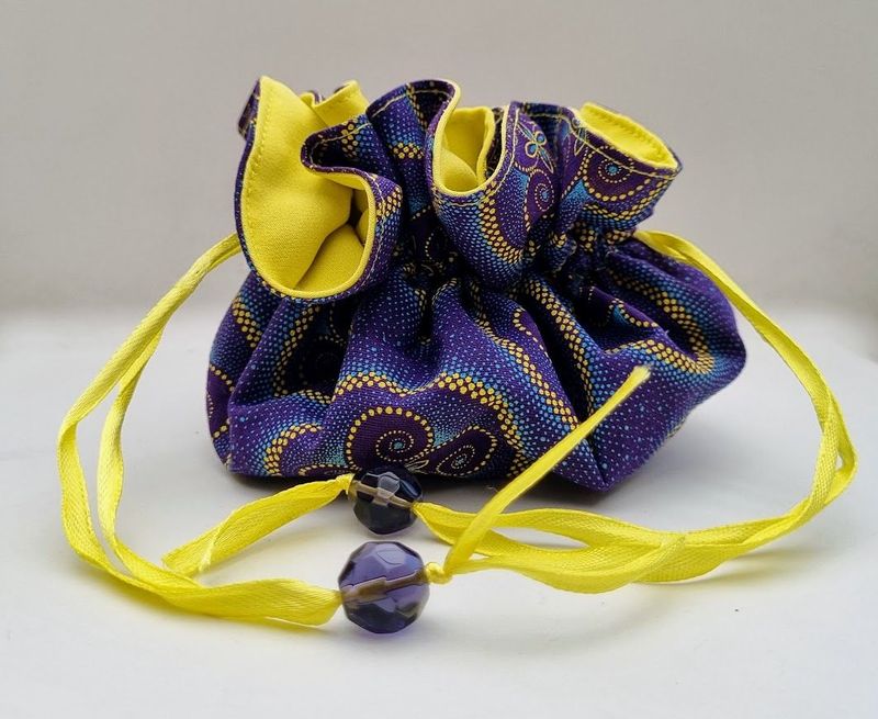 A light and compact travel jewellery bag in vibrant colours of purple and yellow - JB01