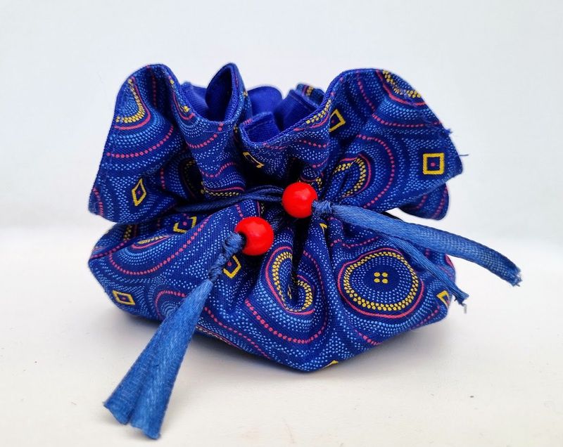 A light and compact travel jewellery bag in blue schwe schwe with red wooden beads – JB04