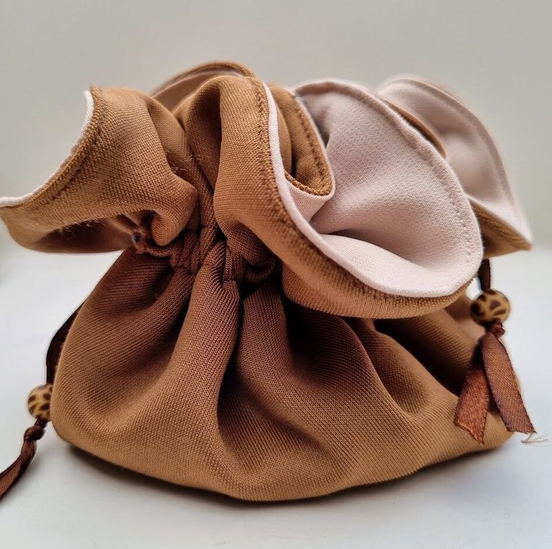 A light and compact travel jewellery bag in neutral colours with giraffe patterned polymer clay beads - JB08